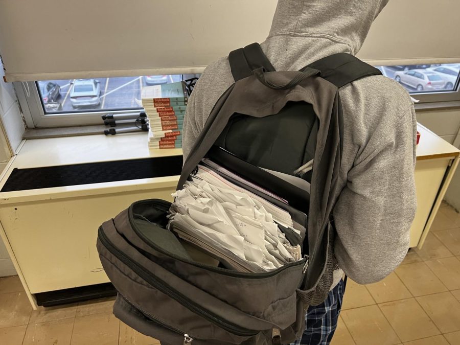 A backpack full of looseleaf papers in a jumble
